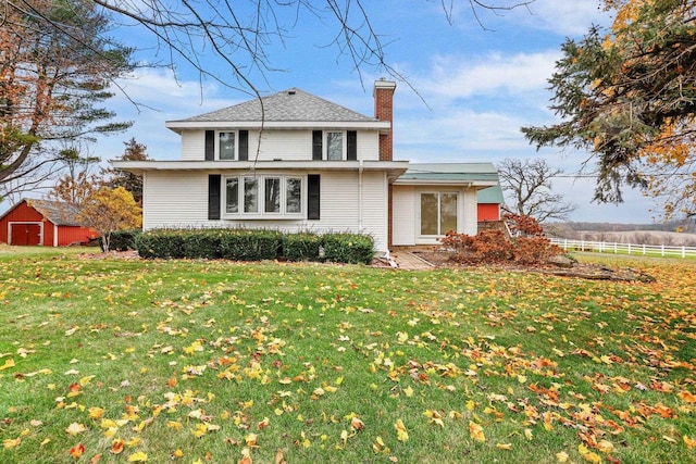 rear view of property with a yard