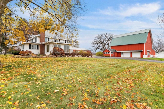 view of side of property with a garage and a yard