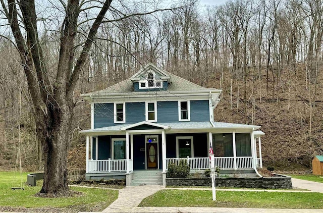 view of front of house with a front yard and covered porch