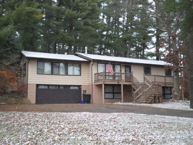 view of front of property with a garage and a wooden deck