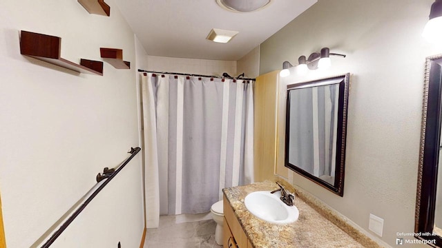 bathroom featuring vanity, walk in shower, and toilet