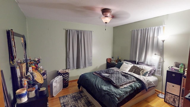 bedroom with wood-type flooring and ceiling fan