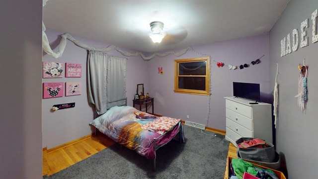 bedroom with wood-type flooring