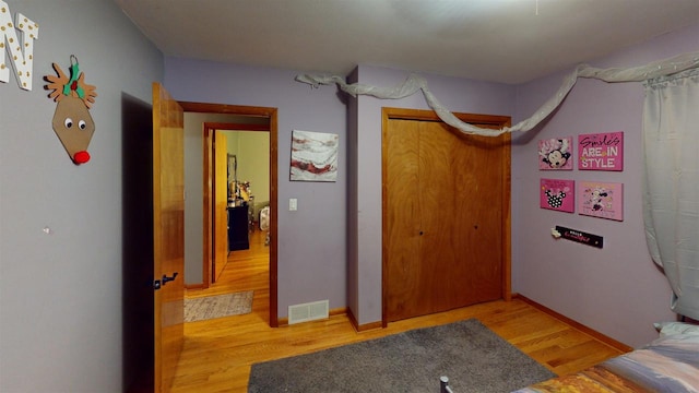 bedroom featuring hardwood / wood-style flooring and a closet