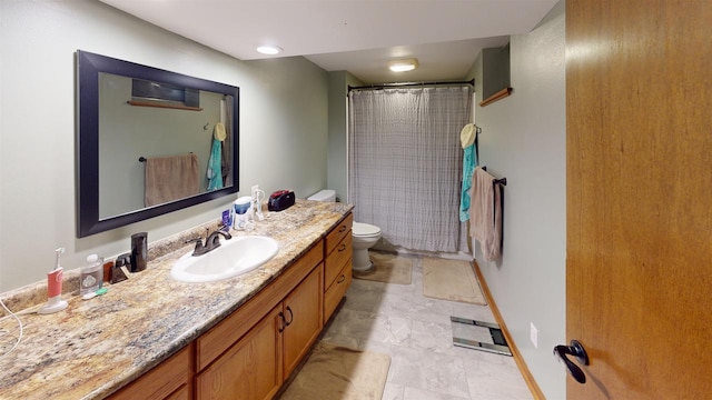 bathroom featuring vanity, toilet, and a shower with shower curtain