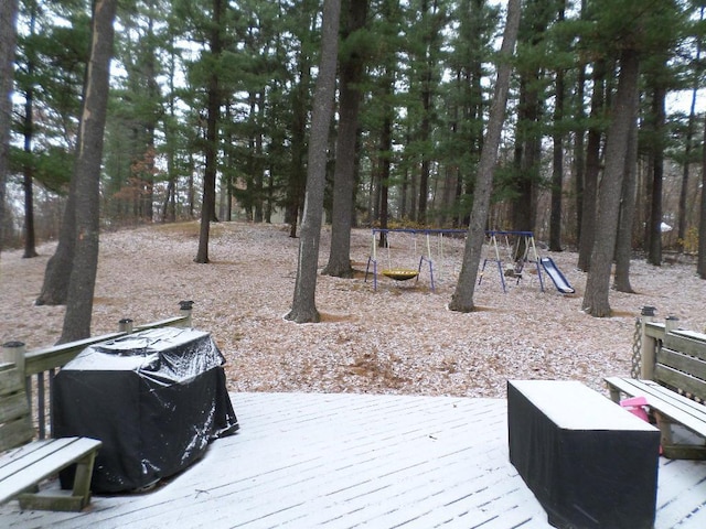 wooden terrace with a playground