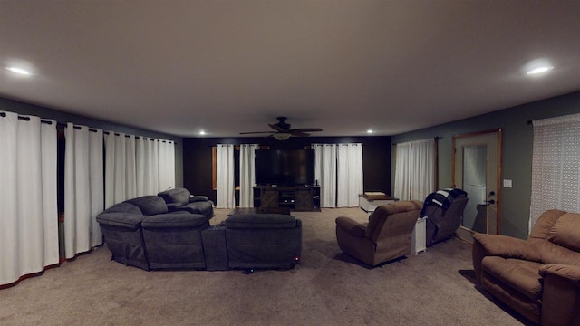 carpeted living room with ceiling fan