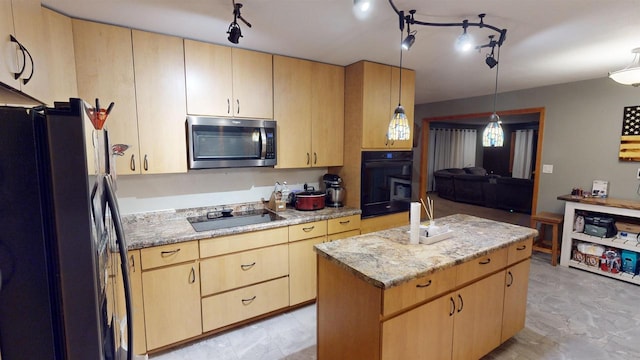 kitchen featuring a kitchen island, light brown cabinets, and black appliances