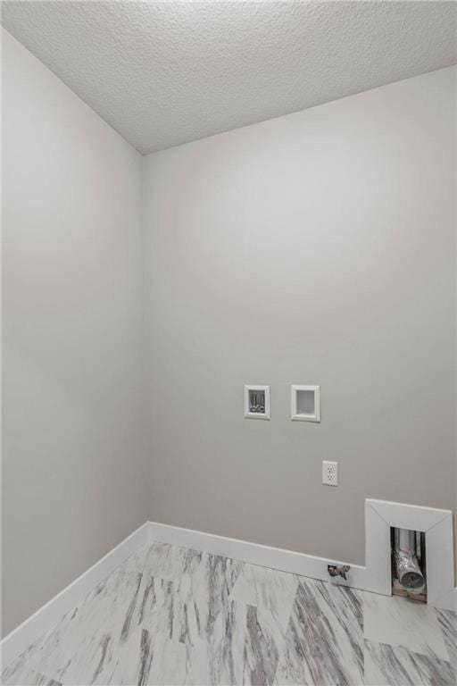 laundry area featuring hookup for a washing machine and a textured ceiling