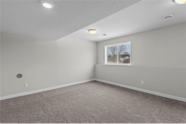 unfurnished room with a textured ceiling and carpet