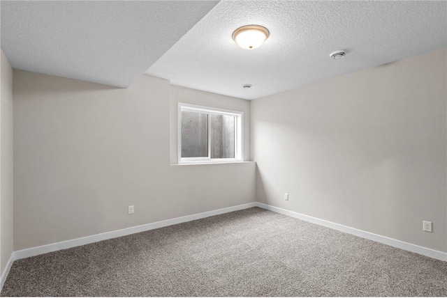 carpeted empty room with a textured ceiling