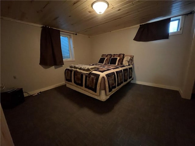 bedroom with wood ceiling and dark colored carpet