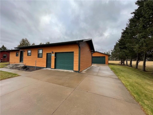 view of front of house featuring an outbuilding, a front lawn, and a garage