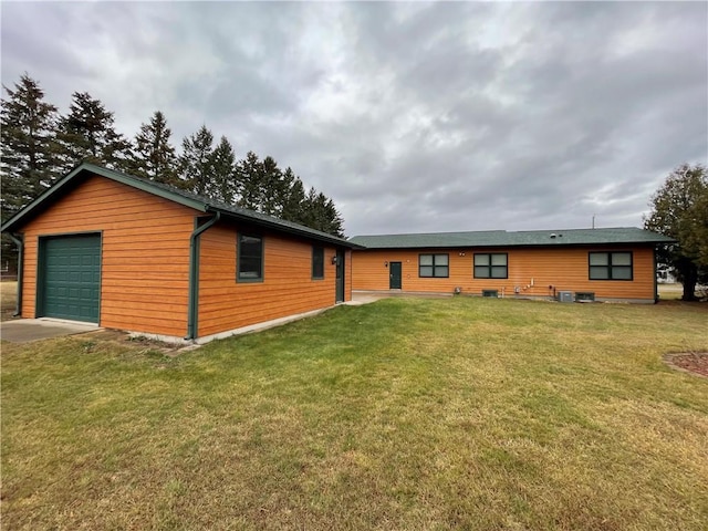 exterior space featuring a garage and a front lawn