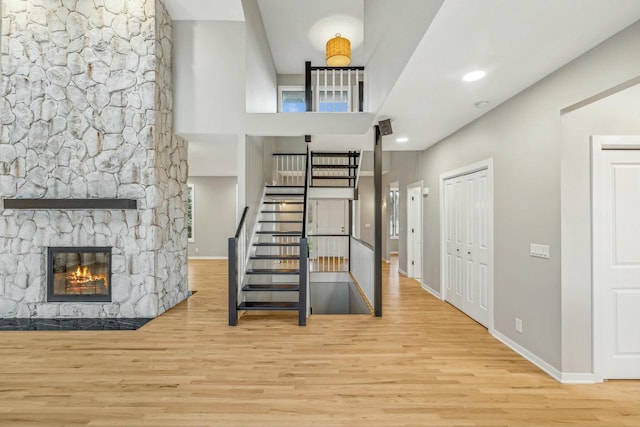 stairs featuring hardwood / wood-style floors and a fireplace