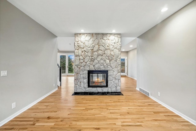 unfurnished living room featuring a fireplace and light wood-type flooring