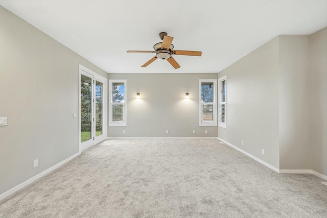 spare room featuring ceiling fan and light colored carpet