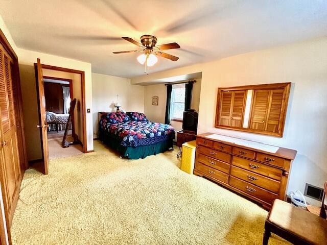 bedroom featuring light carpet and ceiling fan