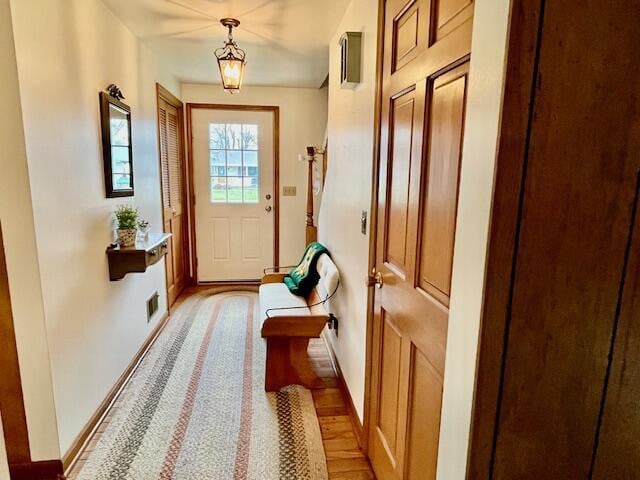 entryway featuring visible vents, light wood-style flooring, and baseboards