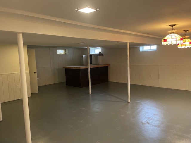 basement featuring wood walls