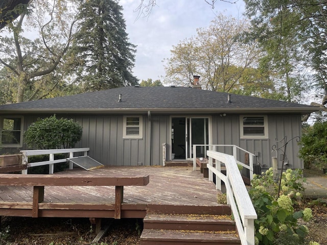 rear view of house featuring a wooden deck