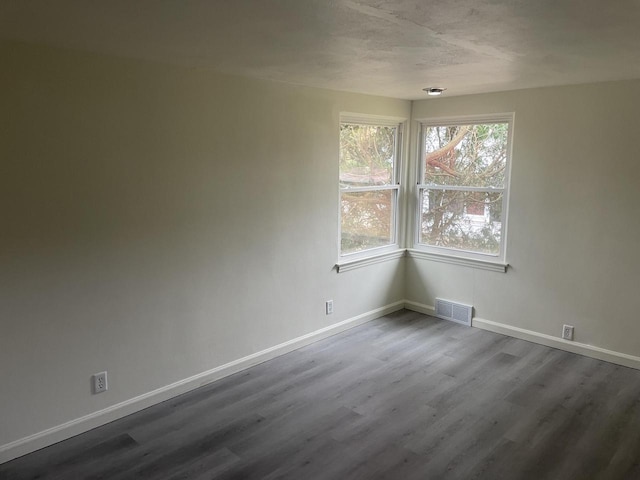 unfurnished room with wood-type flooring