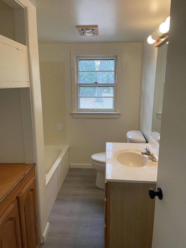 bathroom featuring hardwood / wood-style flooring, vanity, and toilet