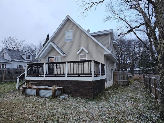 back of house featuring a wooden deck