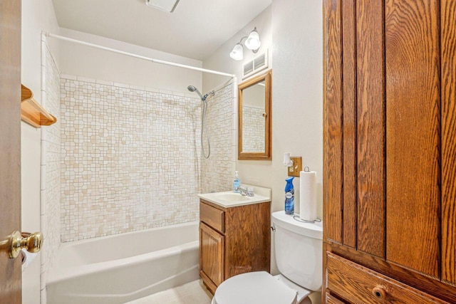 full bathroom featuring toilet, vanity, and tiled shower / bath