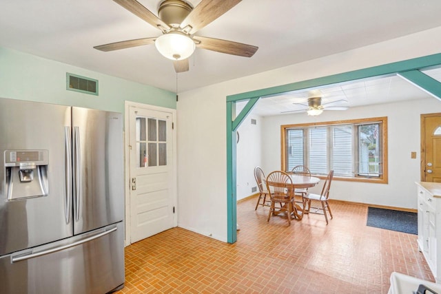 kitchen with ceiling fan, white cabinets, and stainless steel refrigerator with ice dispenser