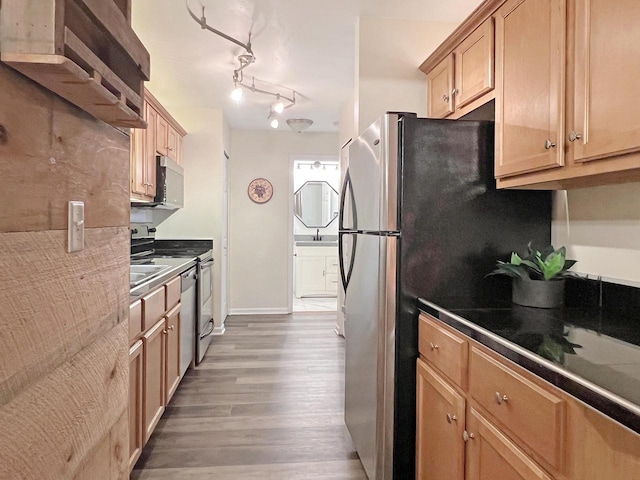 kitchen featuring sink, dark wood-type flooring, and stainless steel appliances