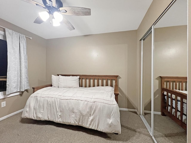 carpeted bedroom with ceiling fan and a closet