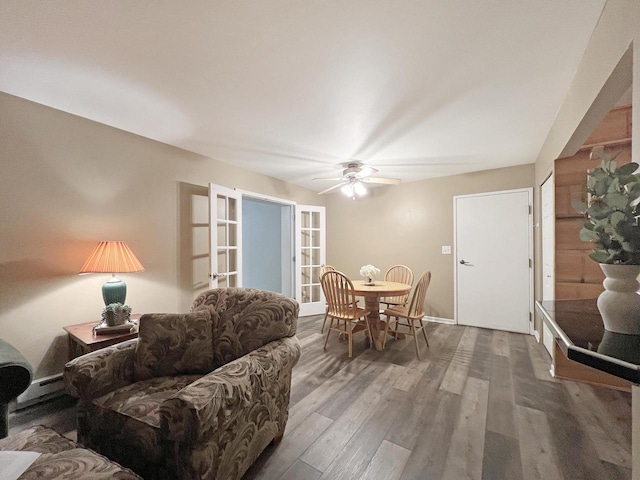 living room with ceiling fan, hardwood / wood-style floors, and a baseboard heating unit