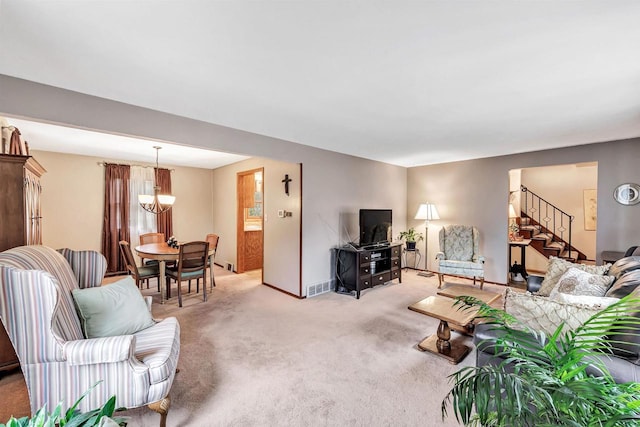 living room featuring light carpet and an inviting chandelier