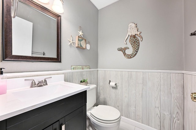 bathroom with tile patterned floors, vanity, and toilet