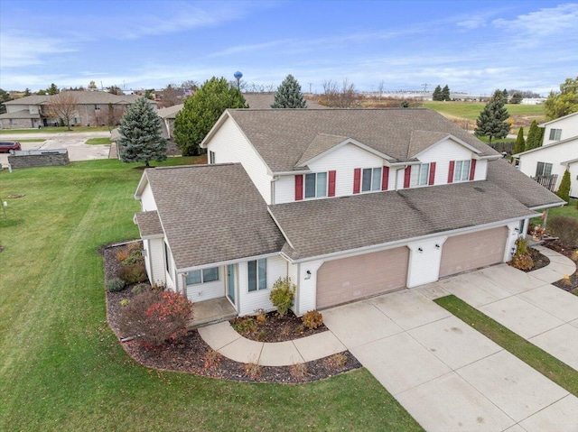 view of front of house with a garage and a front yard