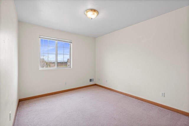 empty room featuring light carpet