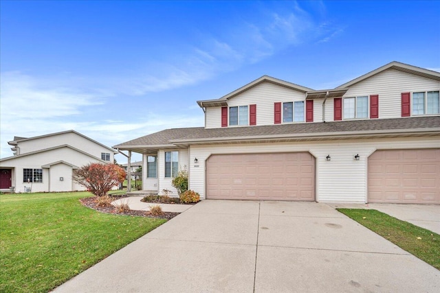 view of front of home with a front lawn and a garage