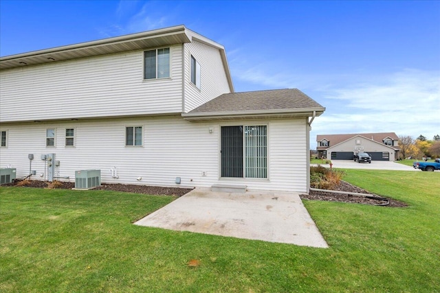 rear view of house with a lawn, a patio area, and central AC