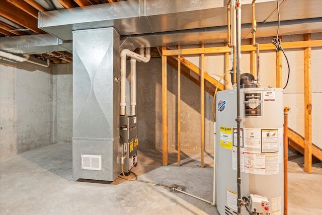 utility room featuring heating unit and water heater