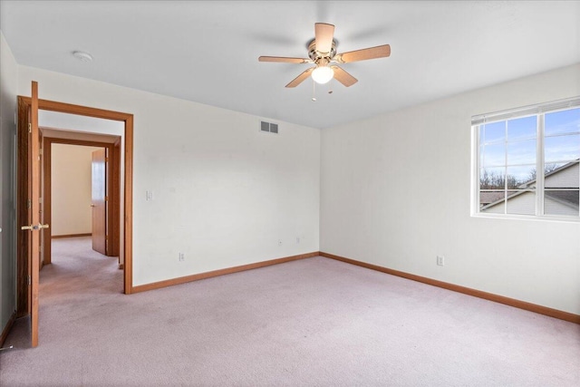 unfurnished room with light carpet and ceiling fan