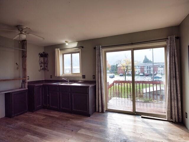 kitchen with light hardwood / wood-style flooring, ceiling fan, and sink