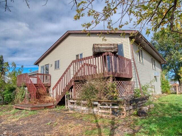 back of property with a wooden deck