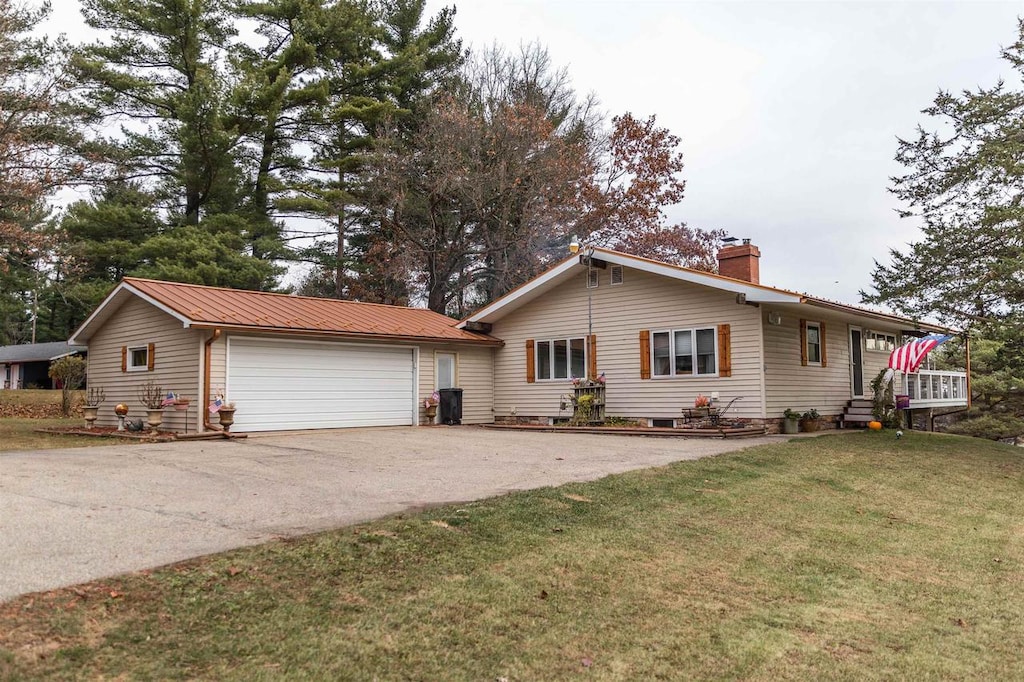 ranch-style home with a front lawn and a garage