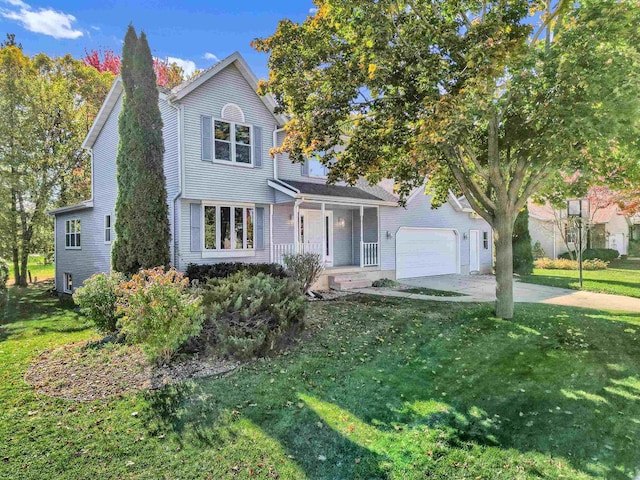 view of front of property with a front lawn, covered porch, and a garage