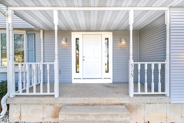 view of exterior entry with a porch