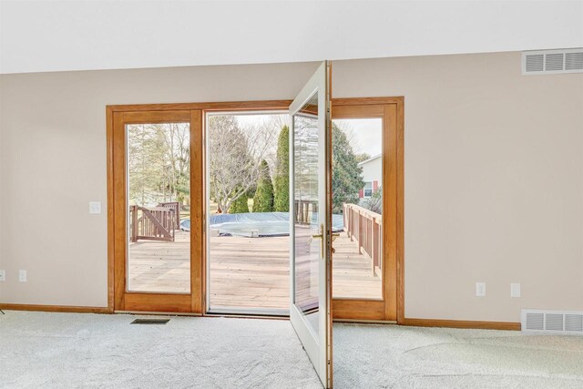 doorway with carpet flooring