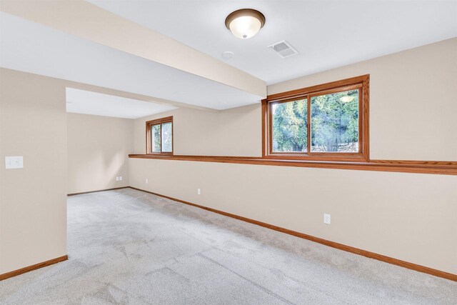 carpeted empty room featuring plenty of natural light