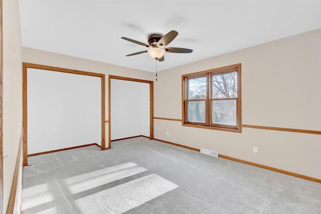 unfurnished bedroom with ceiling fan and light carpet