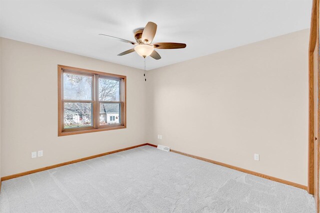 empty room with ceiling fan and carpet floors